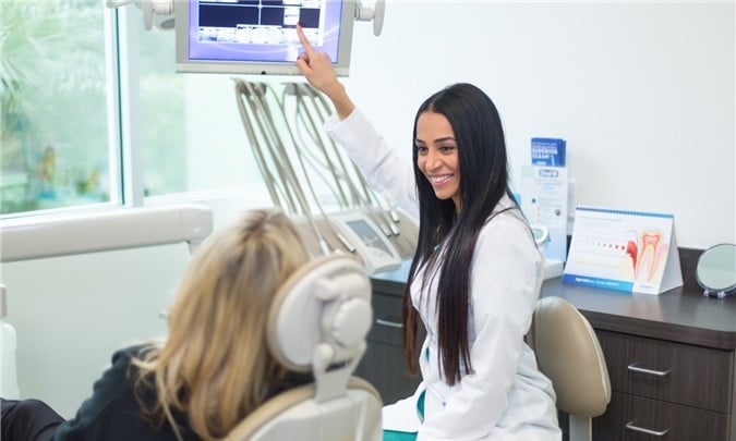 Dr. Pourrahimi in the office with a patient